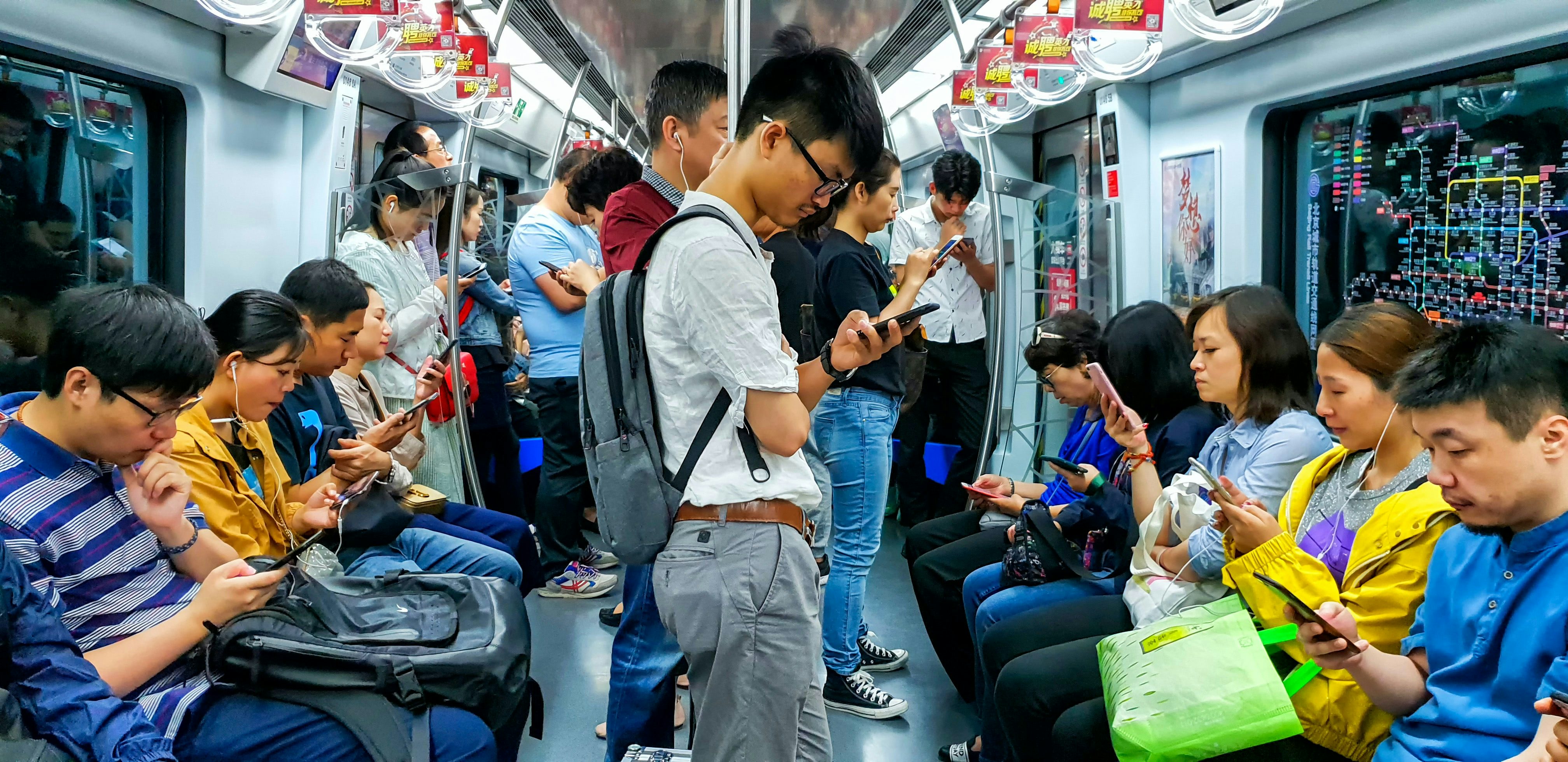 Chinese mobile users commuting in Beijing. Shutterstock